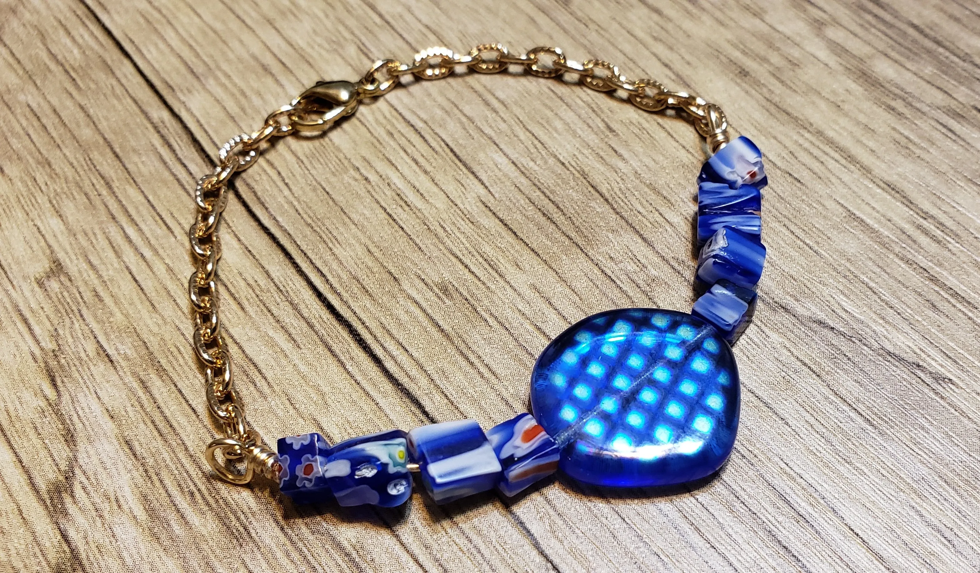 Hand Crafted Blue Millefiori Glass with Focal & Gold Tone Chain Bracelet. Adjustable to 8" with Lobster Claw Clasp