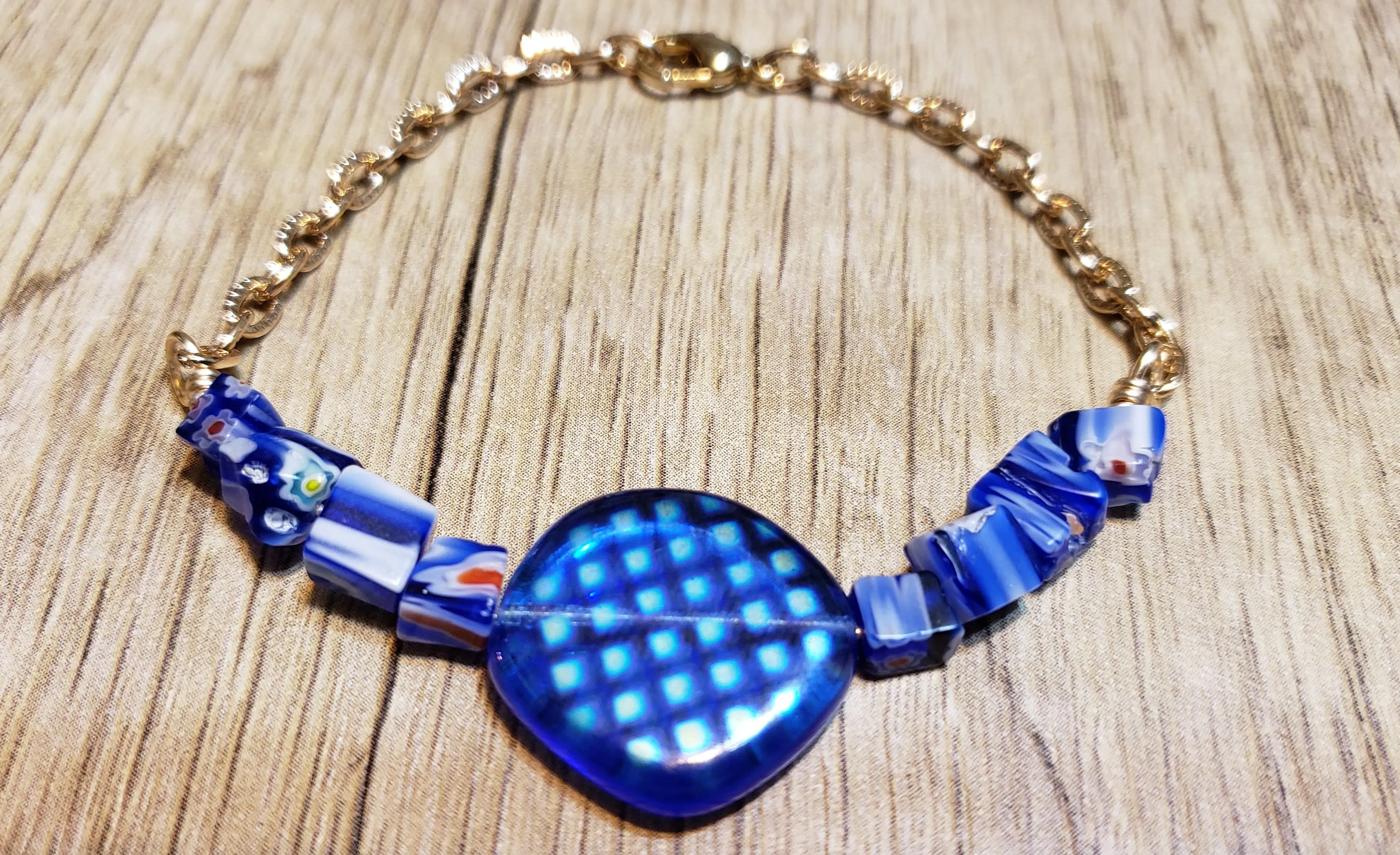 Hand Crafted Blue Millefiori Glass with Focal & Gold Tone Chain Bracelet. Adjustable to 8" with Lobster Claw Clasp